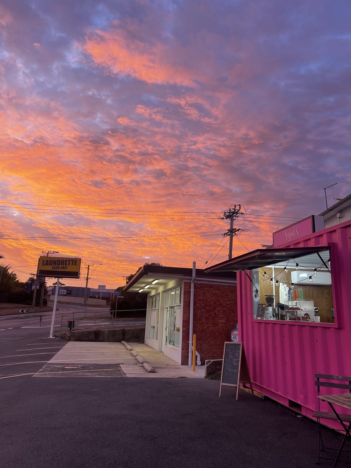 A pink and orange sky over the Sejal's container and Hobart Road